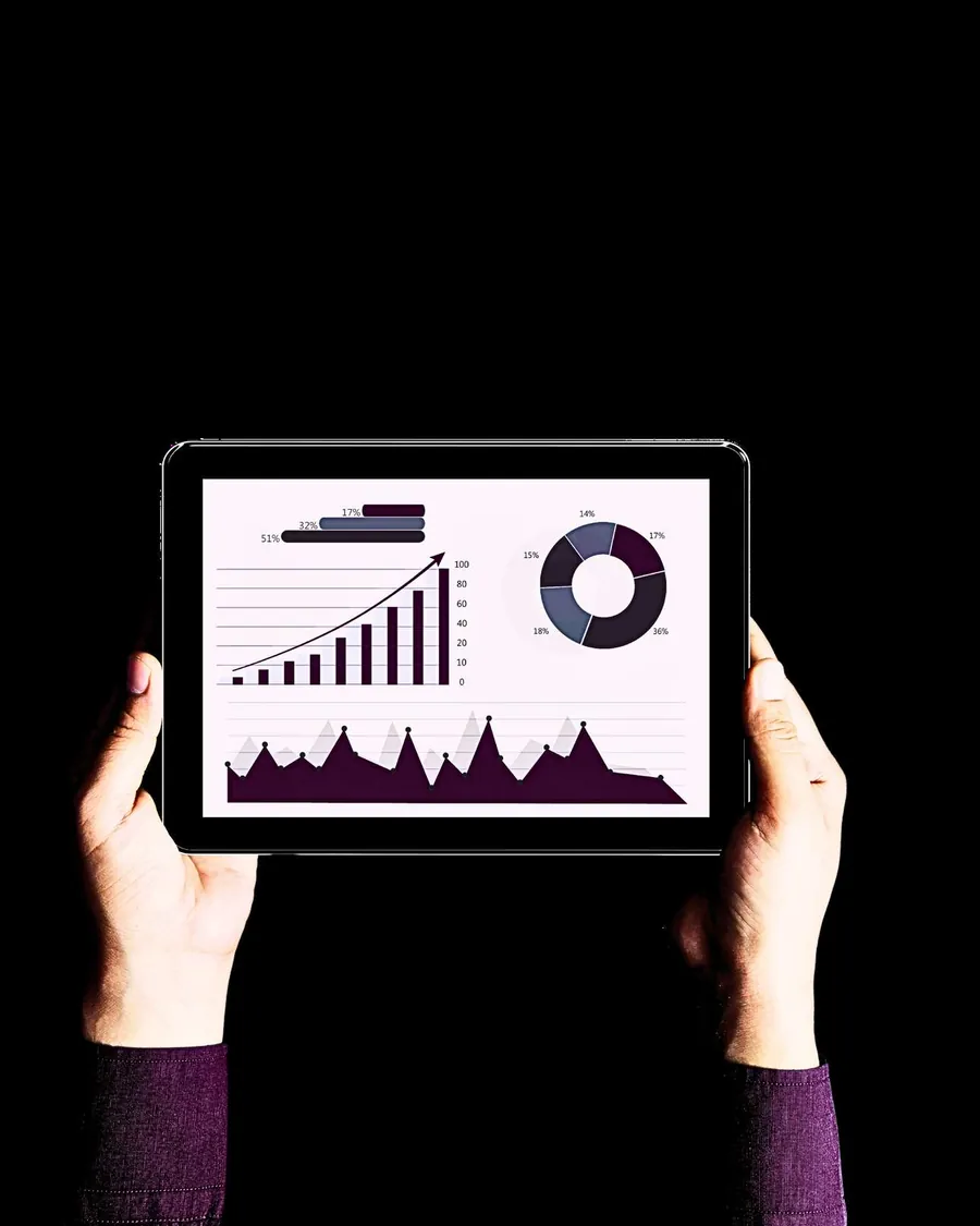 A monitoring dashboard on a tablet showing network uptime and utilisation trends